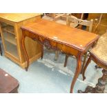 A Mahogany folding tea table with a serpentine top above a frieze centred with a flowerhead crest,