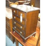 A Reproduction miniature chest of two short and three long drawers.