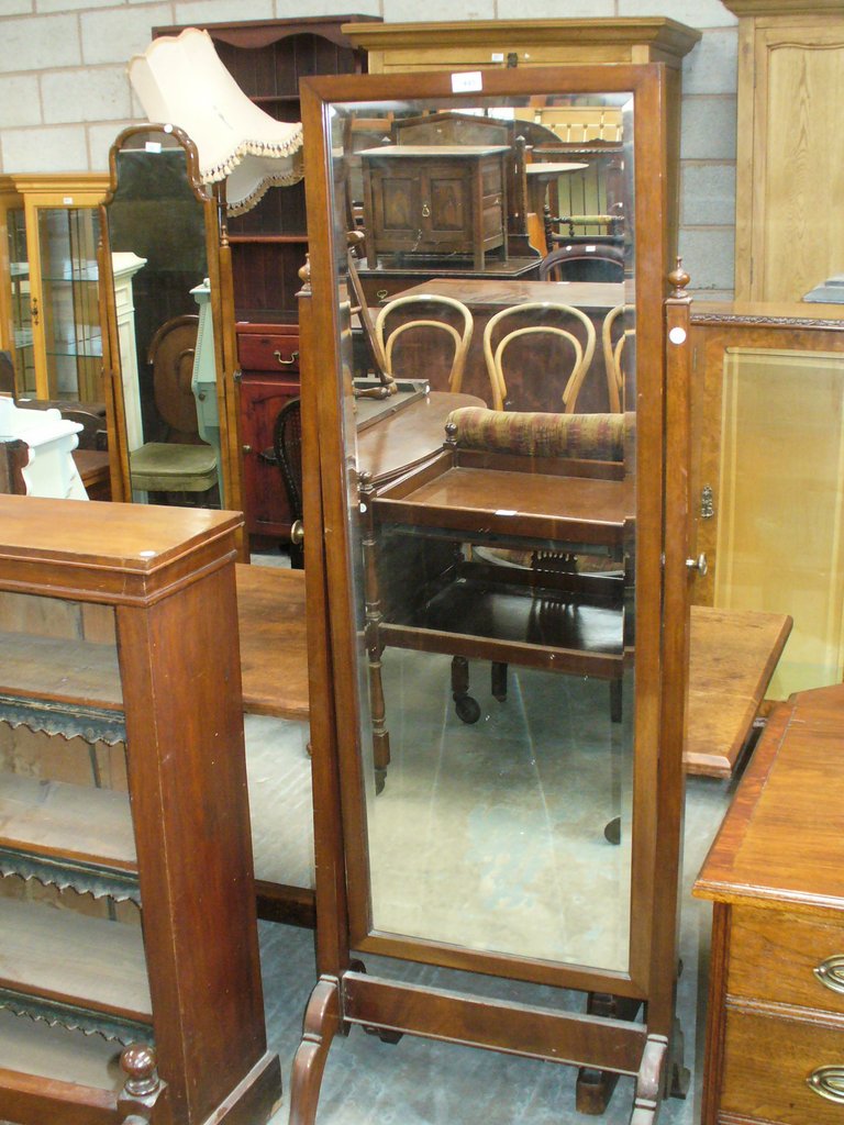 An Early 20th Century mahogany cheval mirror with a rectangular plate supported on uprights of
