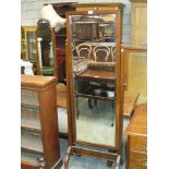 An Early 20th Century mahogany cheval mirror with a rectangular plate supported on uprights of