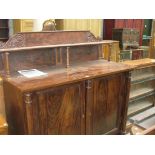 A Regency mahogany sideboard The raised back with a shelf supported by three ring turned tapering