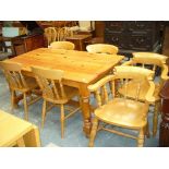 A Rectangular pine kitchen table with a plain cross stretcher,