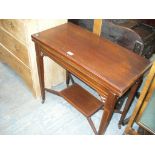 An Edwardian inlaid mahogany folding games table, legs of tapering square section.
