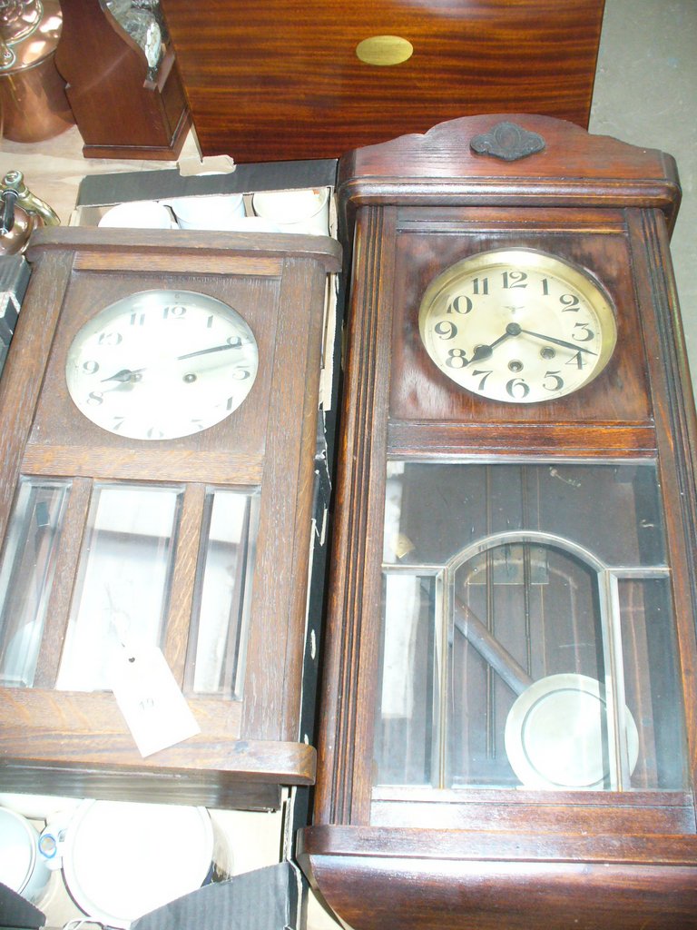 An Early 20th century oak cased wall clock with a silvered dial and a second similar clock.