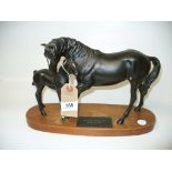 A Beswick matt group " Black Beauty and foal" upon a hardwood plinth.