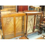 A 1930's Walnut display cabinet on ball and claw feet and a second similar cabinet.