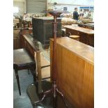 A 19th Century style mahogany torchere the circular top with a rope border raised on tapering