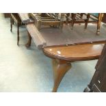 An Early 20th Century mahogany extending dining table on cabriole legs and pad feet ,