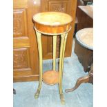 A French Empire style Satinwood torchere The circular top with carved giltwood beaded border,