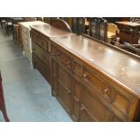 A Mid 20th century oak sideboard with two drawers above two panelled cupboard doors,