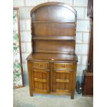 A reproduction Dutch style oak dresser with two drawers and two cupboard doors.