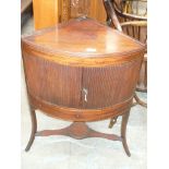 A Georgian mahogany corner washstand The rectangular hinged top concealing three circular apertures