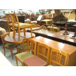 A reproduction yew wood dining room suite comprising a circular pedestal extending table,