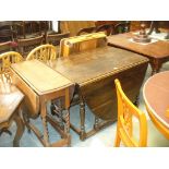 An Early 20th Century oval oak drop leaf dining table on ring turned baluster supports and a 1930's