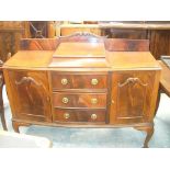 An Early 20th Century mahogany sideboard with three central drawers flanked by two cupboard doors