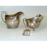 A Georgian silver cream jug with a reeded border and angular handle,