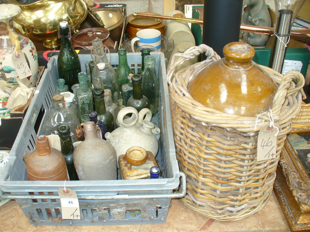 A Collection of old glass and stone ware bottles and a stoneware flagon.