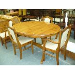 A Modern pine pedestal kitchen table with four conforming chairs.