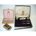 A Cased silver handled manicure set, incomplete, a cased nutcracker and pick set,