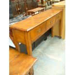 A Contemporary rustic oak three drawer dresser raised on legs of tapering square section with brass