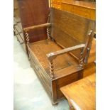 A 1920's Oak monks bench with barley twist supports ,