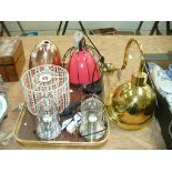 A hanging pendant light with a black wire work cage and a pair of chromed domed glass table lamps