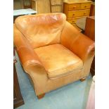 A Modern tan leather easy chair.