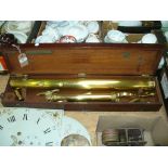 A Brass telescope and tripod to a mahogany box.