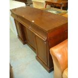 A Victorian mahogany inverted break front sideboard with three drawers and three cupboard doors.