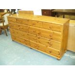 A Modern pine chest with an arrangement of ten drawers.