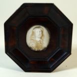 An antique miniature portrait inset within tortoiseshell veneered frame The central hand-painted