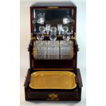 An Edwardian inlaid mahogany cased gentleman's decanter & games box The hinged cover lifts to