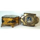 A late 19th/early 20th century jewellery casket of shaped oval form The central glass cover lifts