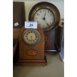 An Edwardian inlaid mahogany balloon shaped mantel clock with three further mantel clocks.