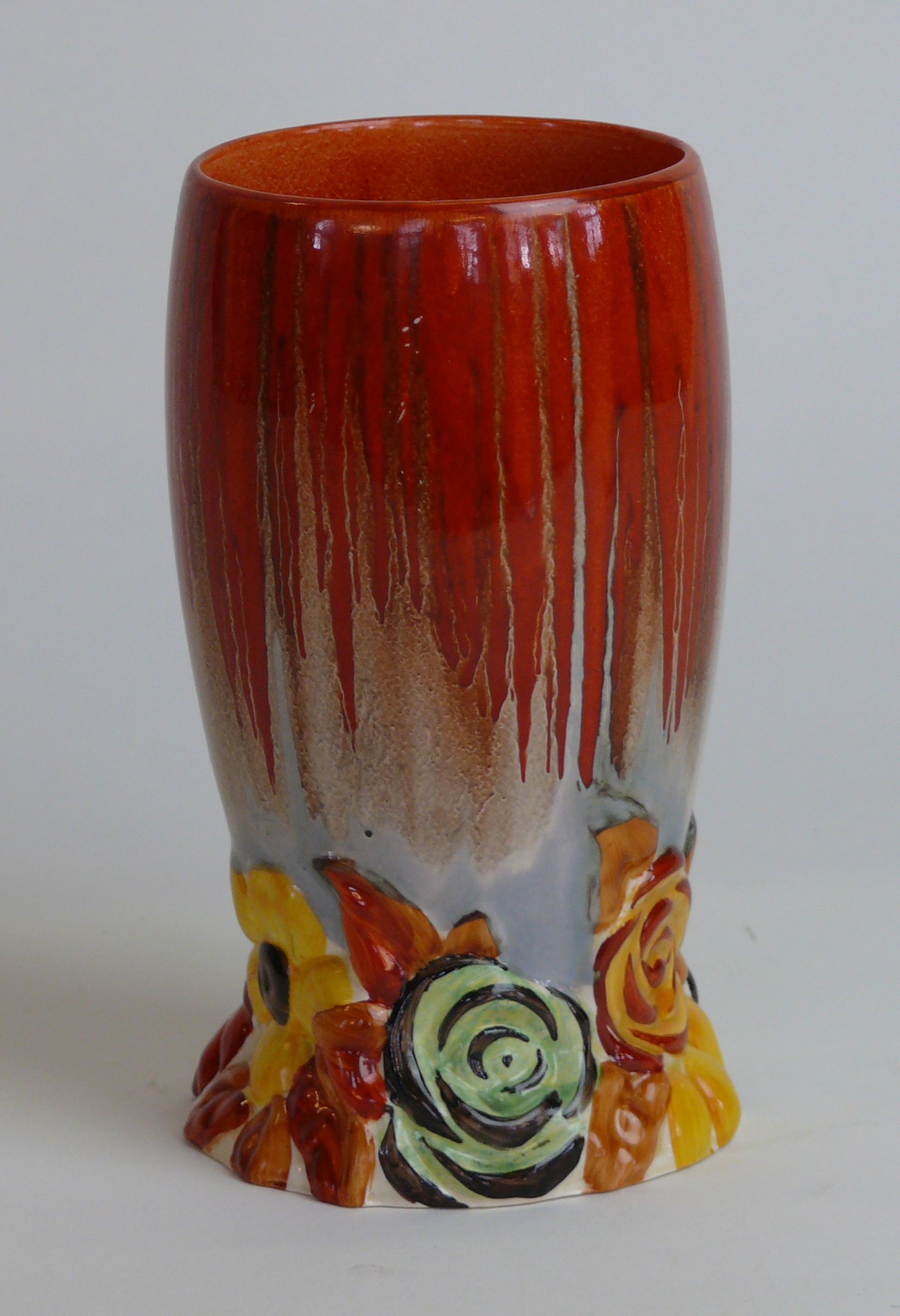 A Clarice Cliff vase of cylindrical form Decorated in the 'My Garden' pattern on a dripped red and