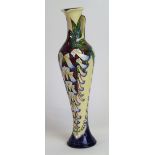 A modern Moorcroft pottery jug of slender cylindrical form Decorated with stylised flower heads and