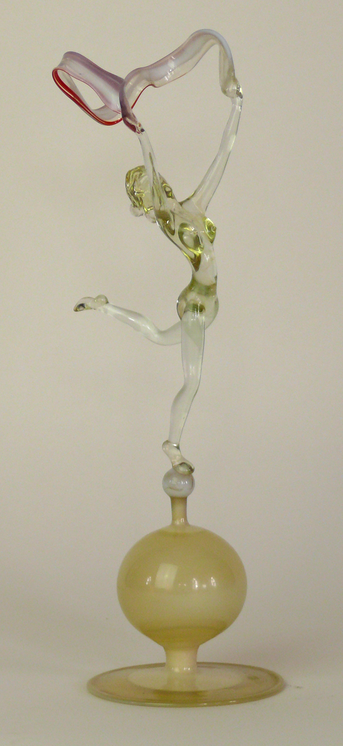 An Art Deco Istvan Komaromy blown glass figure Modelled in the form of a nude dancing girl holding