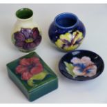 Four pieces of Walter Moorcroft pottery To include a Clematis vase,