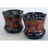 A pair of William Moorcroft pottery jardineres of square form Decorated in the Pomegranate pattern