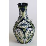 A modern Moorcroft pottery vase of baluster form Decorated with stylised flower heads on an ivory