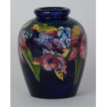 A Walter Moorcroft pottery vase of ovoid form Decorated in the Orchid pattern on a blue ground,