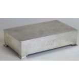 An Art Deco style hallmarked silver rectangular cigarette box The cover having engine turned