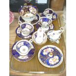 A 19th Century cobalt blue gilt and floral pattern tea service comprising cups, saucers, slop bowl,