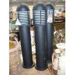 Three black cylindrical outdoor column lamps (3).