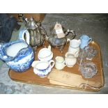 A Blue and white earthenware landscape jug, other assorted jugs, vintage wooden butter pats,