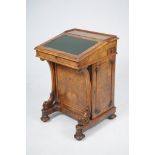 A Victorian burr walnut davenport The hinged leather inset writing slope concealing a maple