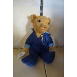 An Invicta 1940s/50s gold plush teddy bear, with glass eyes and articulated limbs, in blue jumpsuit,