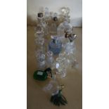 A collection of assorted glass perfume bottles to include a hallmarked silver collared example.