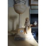 A 20th alabaster table lamp base, modelled in the form of a jester playing a lute,