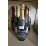 Five bottles of assorted sparkling wine.